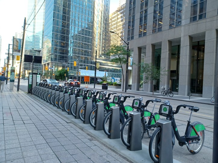 Such bike stations are there throughout the city, totaling 625. A bike can be taken from any stand and dropped at any other. The bikes are rented through an app. As can be seen in the picture, the bike station is powered by solar panels.