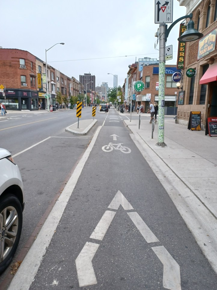 A bike lane and pedestrian path. They are usually side-by-side throughout the city. This bike lane is elevated.